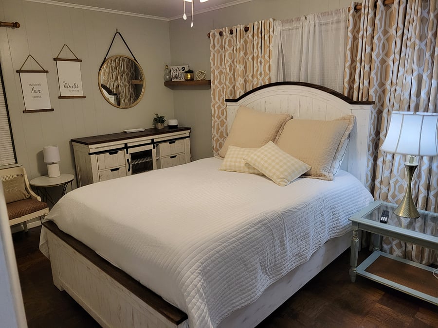 The master bedroom is retreat away from the kiddos. It's cozy with a large window.