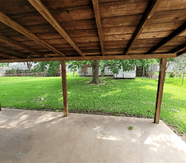 Larger covered patio. Large fenced yard with outside storage. Bar-be-que pit for outside drilling and family functions. 
