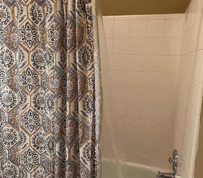 With a bathtub and shower combo.