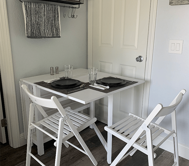 Dining area doubles as a desk, and can fold down when not in use. It blocks the entrance to the rest of the house (door is locked from the other side)