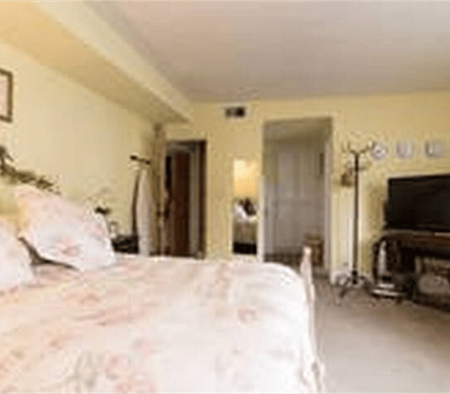 Large Private Bedroom with seating area and TV