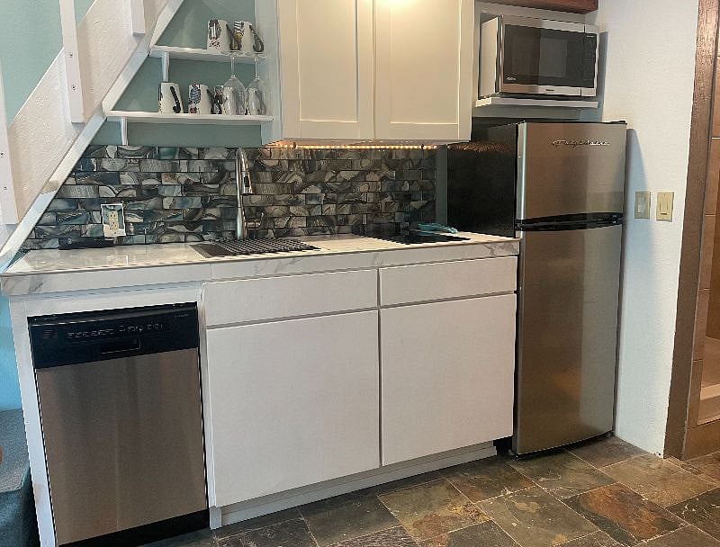 Small fridge. 2 burner electric cooktop. microwave, dishwasher. 