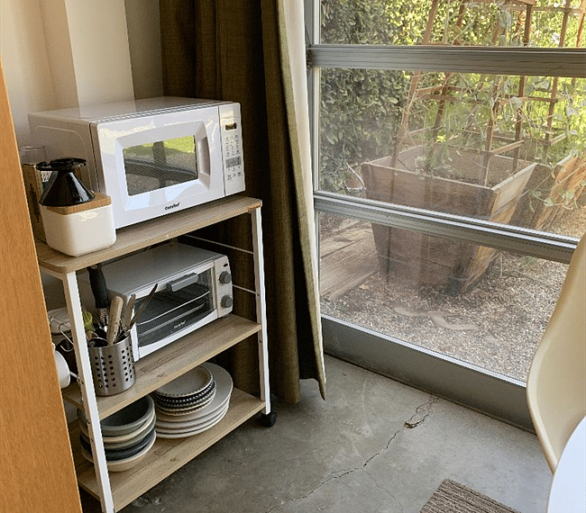 Microwave, toaster oven, pour-over coffee, cutlery, utensils, plates, bowls, cups, glasses, and other items provided