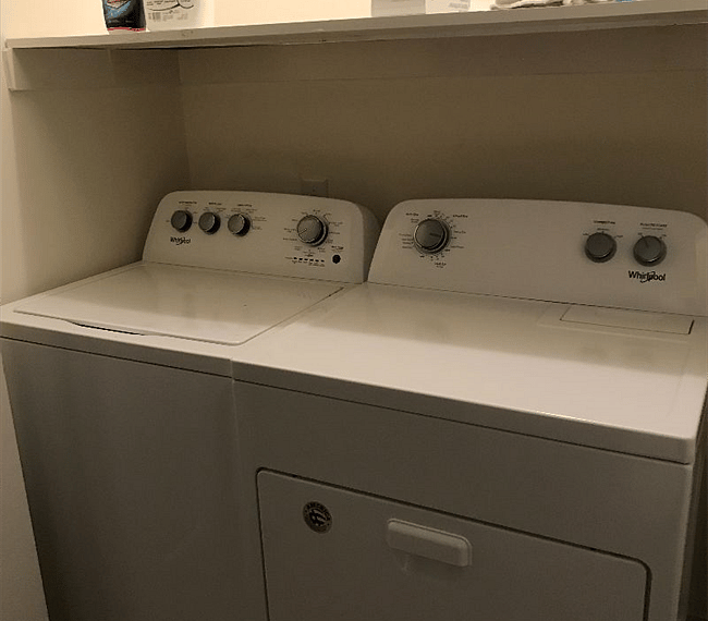 Full size washer and dryer tucked away in a hall closet.  A handheld steamer is also stored here to get rid of any wrinkles you may have.  There are shelves to store all your cleaning supplies.