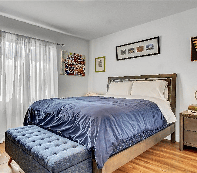 Master bedroom with 58" Ultra 4K SmartTV and pull-down blackout shades for privacy