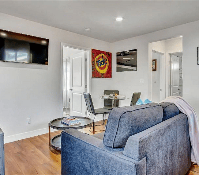 Living room with 43-inch Ultra 4K SmartTV, dining nook, and coffee/tea station