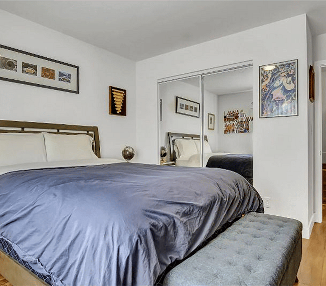 Master bedroom with 58" Ultra 4K SmartTV and pull-down blackout shades for privacy