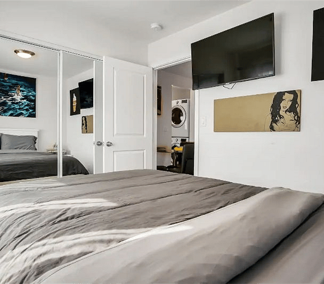 Guest bedroom with 43" Ultra 4K SmartTV and pull-down blackout shades for privacy
