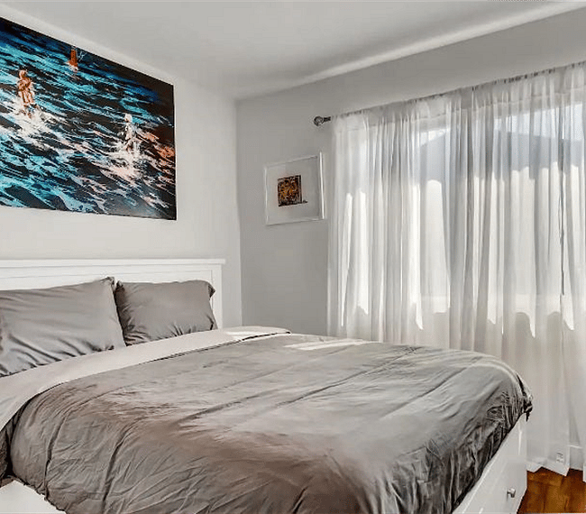Guest bedroom with 43" Ultra 4K SmartTV and pull-down blackout shades for privacy