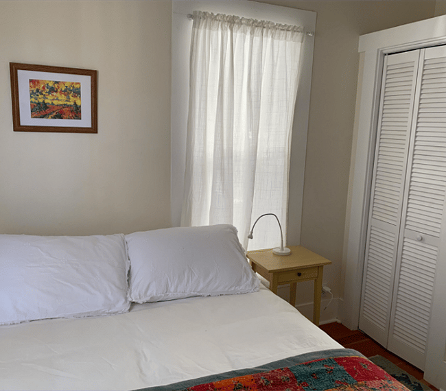 The bedroom is light and sunny and has a large closet and a dresser.