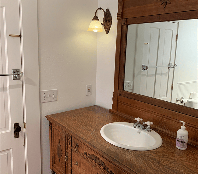 Bathroom with door leading into the bedroom.