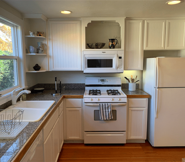 A gas stove, dishwasher and plenty of storage space in the kitchen.