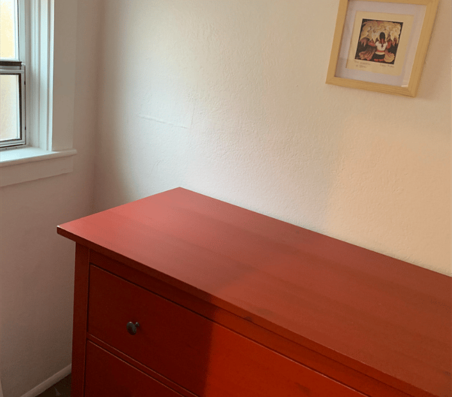 A small storage room with a large dresser leading off the second bathroom.