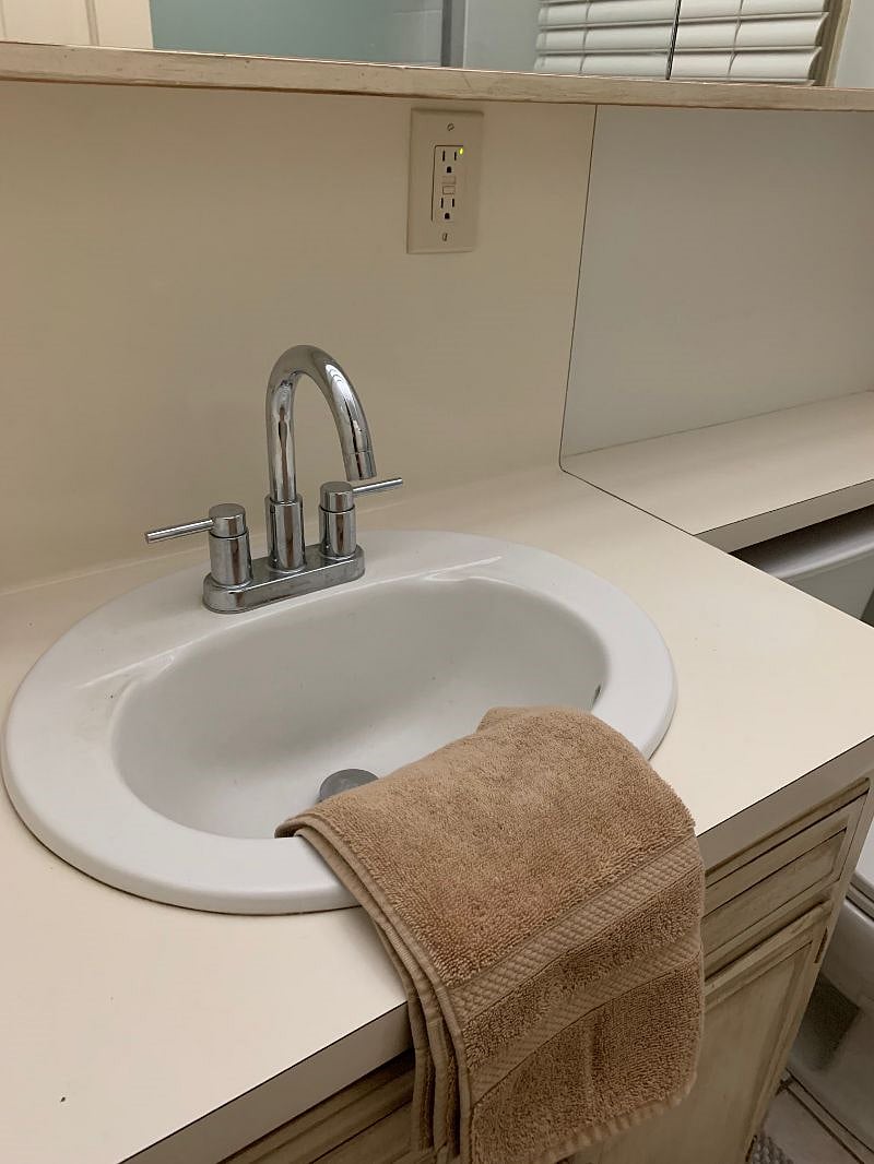 NEW FAUCET that turns to the side to make it easy to wash dishes.