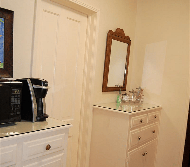 Door to bathroom between 2 built in storage cabinerts