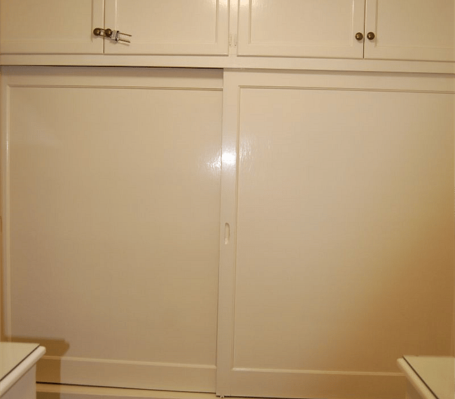Closet with sliding door and hangers included. Storage drawers underneath.