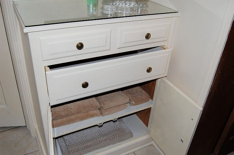 Another view of the ample storage in the built in cabinets that flank the bathroom door.