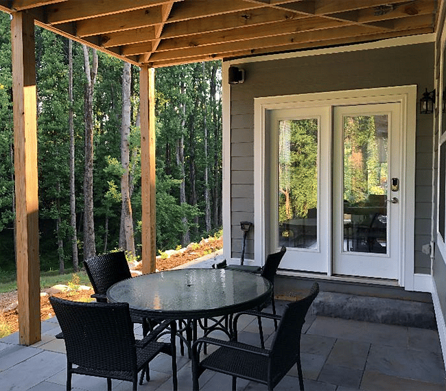 Enjoy a covered patio for relaxing and enjoying a meal outside. The wooded view and gardens are urban delight. 