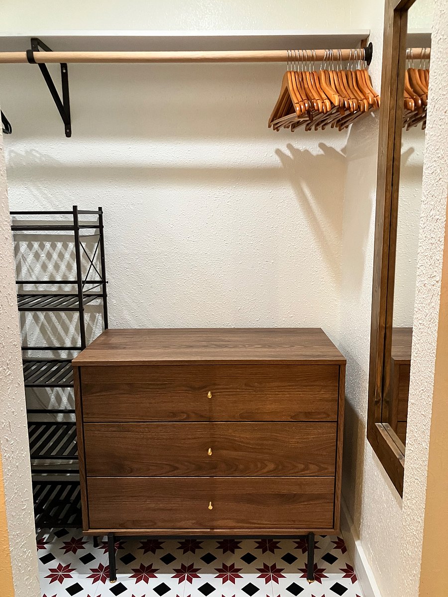 Walk-in Closet: dresser, full-length mirror, laundry basket, extra storage shelves.