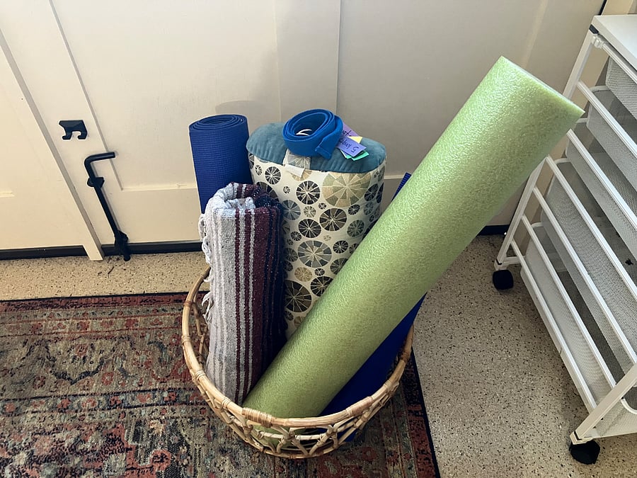 Yoga supplies and space to roll out your mat in the entryway.