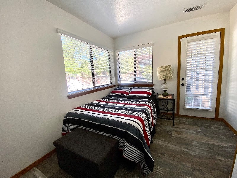 Bedroom 2/office, with access to the backyard and the pool and the grill.