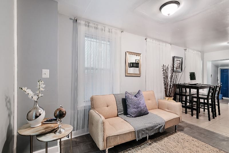 Lovely living room with sofa, flat screen 43" smart TV, dining area connected and comfortable chairs.