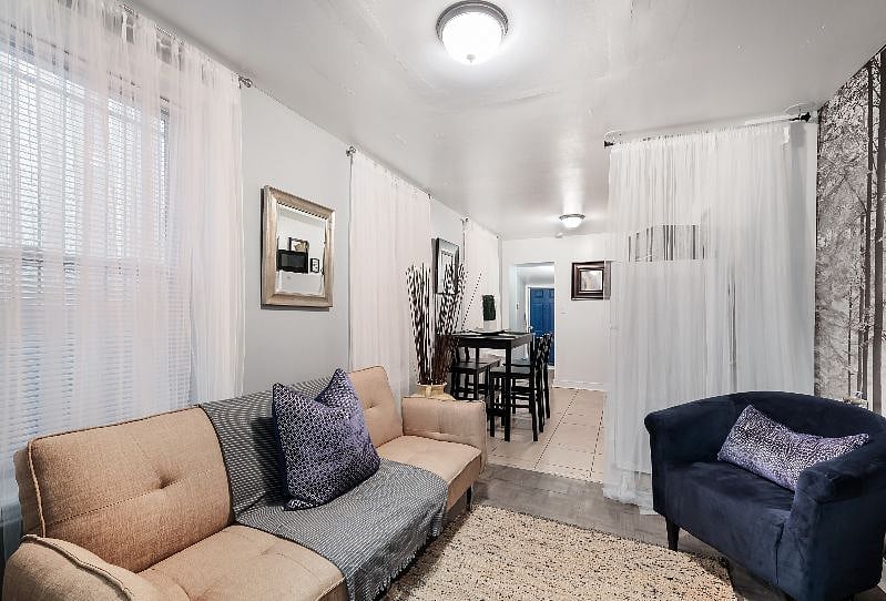 Lovely living room with sofa, flat screen 43" smart TV, dining area connected and comfortable chairs.