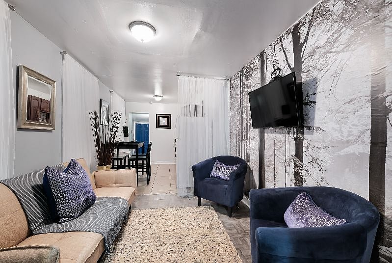 Lovely living room with sofa, flat screen 43" smart TV, dining area connected and comfortable chairs.
