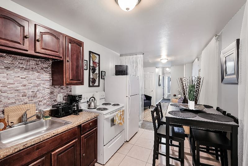 Modern new dining area with seating for 4 plus extra chairs on site, tall seating type.
