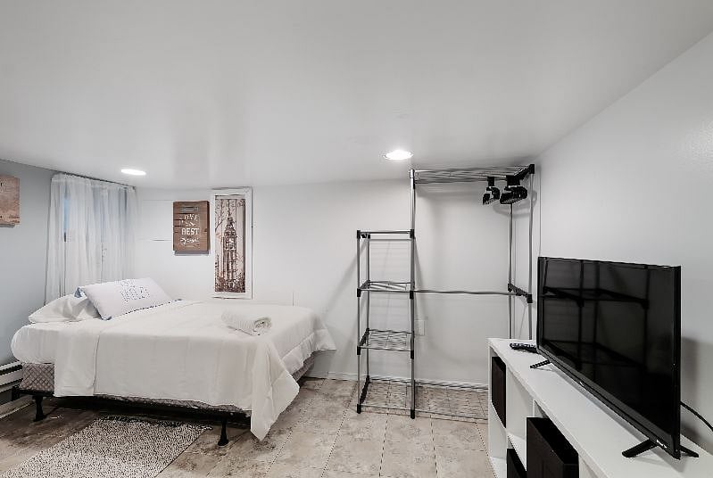 an aesthetic queen-sized bedroom, the space is characterized by a blend of luxurious fabrics, serene color tones, and carefully curated decor that exudes comfort and elegance.