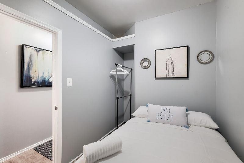 an aesthetic queen-sized bedroom, the space is characterized by a blend of luxurious fabrics, serene color tones, and carefully curated decor that exudes comfort and elegance.