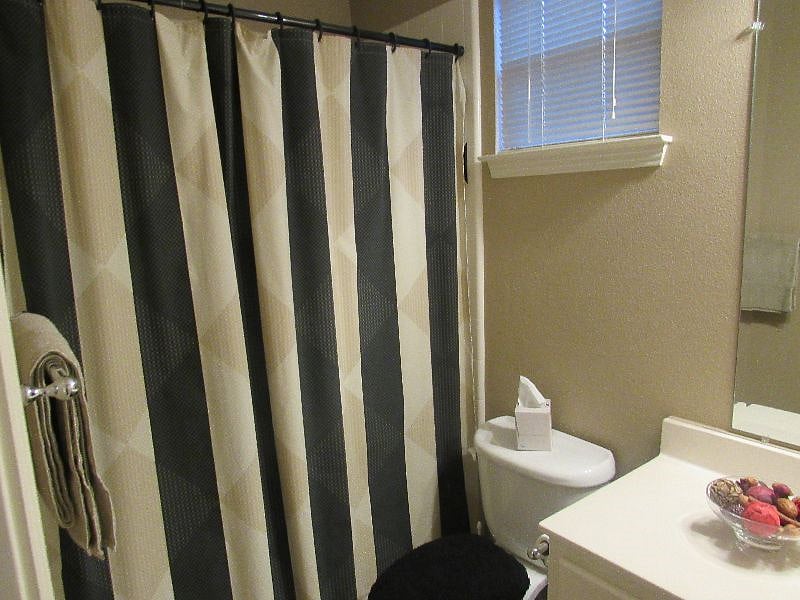 Full size bath -Tub with shower, sink, toilet.
