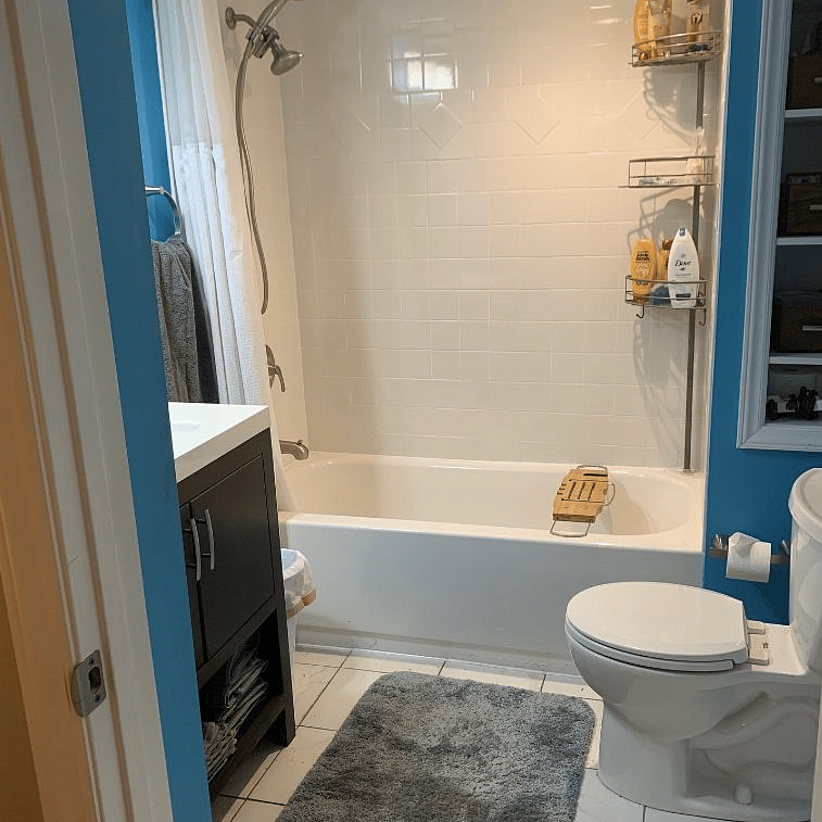 Shower/tub with handheld spray, and more storage. Heater and vent in ceiling unit.