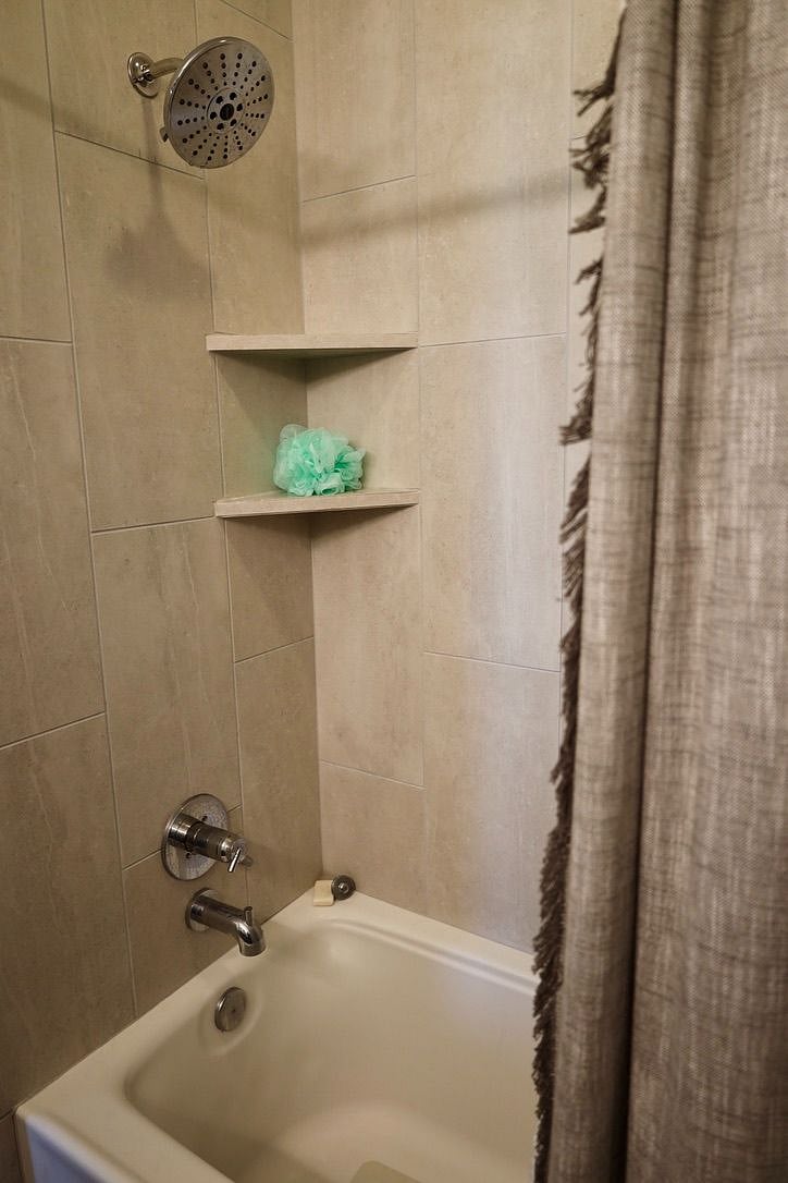 Bedroom 1 ensuite. Tub with shower.