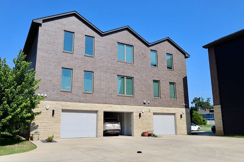 Rear view. Garage access from the alley. Garage door controlled by remote.