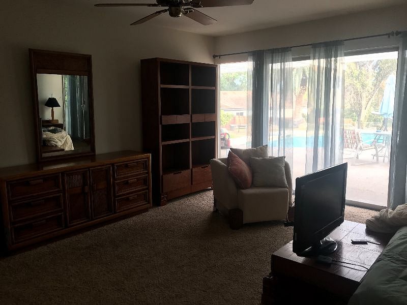 Bedroom with view of back yard. windows equipped with black out curtains