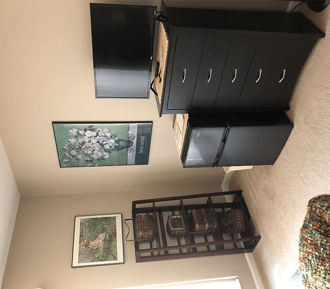 Small refrigerator with separate freezer on top, flat screen tv and chest of drawers