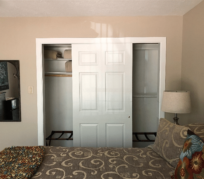 Spacious double closet with shelves, luggage racks, full-size ironing board and iron.  Extra linens and blankets.
