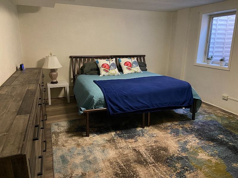 Large bedroom, king bed, two dressers, two end tables, desk, egress window, closet.