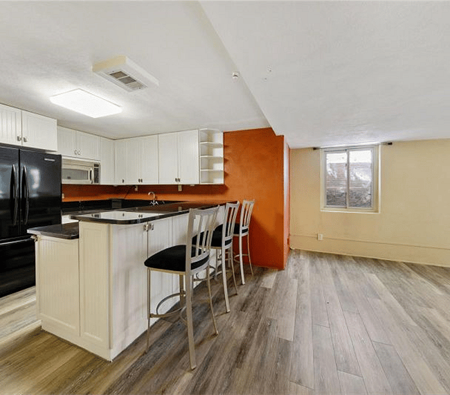 Full kitchen, 3 barstools.  Room to right IS furnished, see photos of the Living Rooms.
