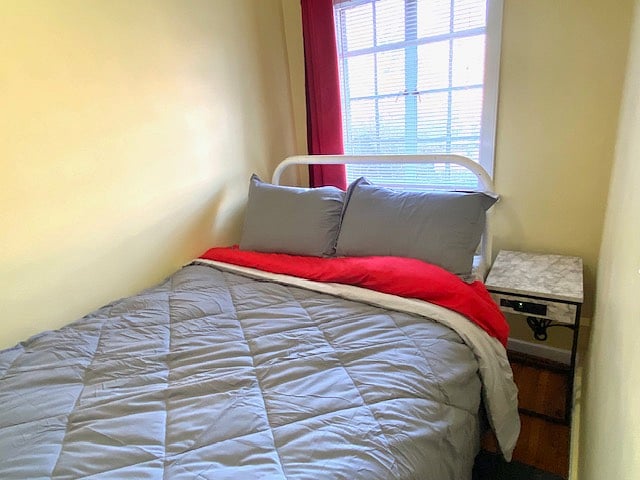 Private bedroom with bedside phone charging stand.