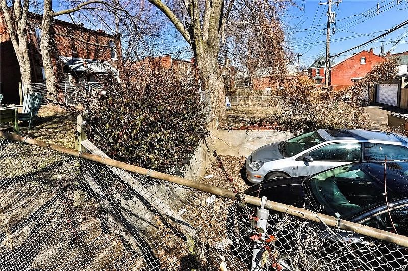 There is a parking pad that can accommodate two cars in the back that is part of the property--as long as the cars aren't giant.