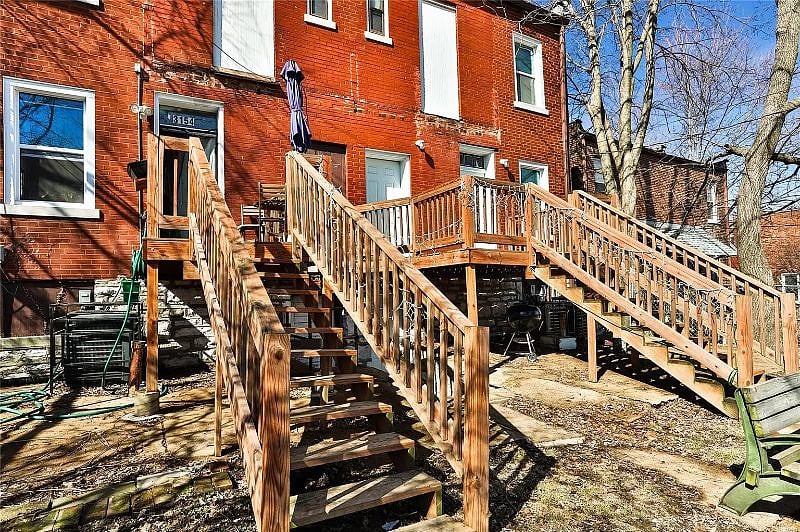 The back door leads to a small deck and back yard and down to the parking pad.