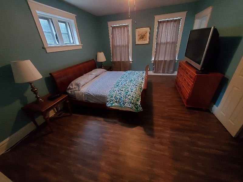 This is the larger upstairs bedroom with a king bed and a TV and large walk in closets
