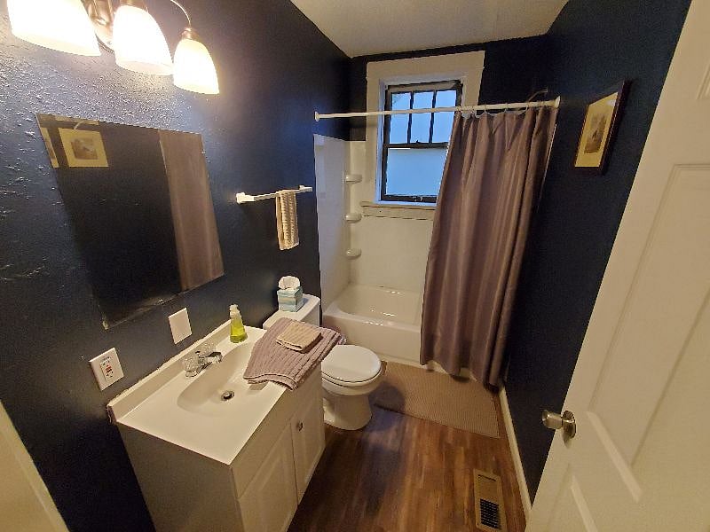 The first floor bathroom with shower, tub, and linen closet