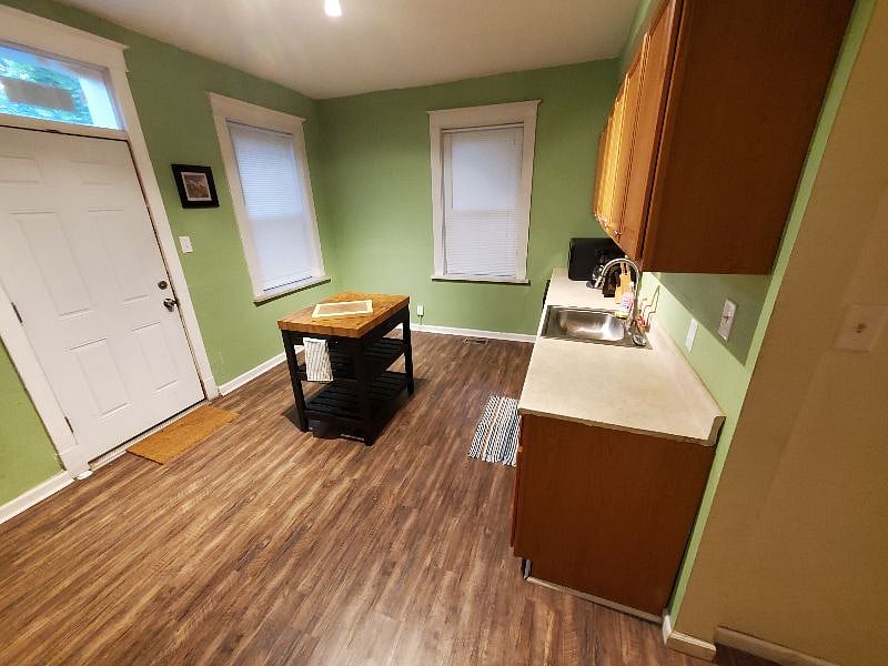 Another view of the kitchen and rear entrance door
