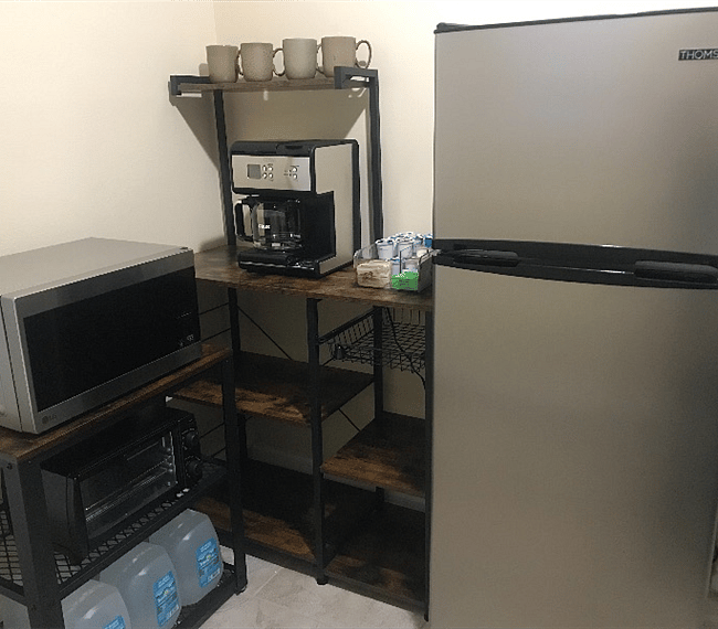 Coffee brewer, microwave, and toaster oven in kitchenette