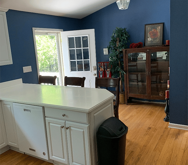 Eat in kitchen with barstools and hardwood floors