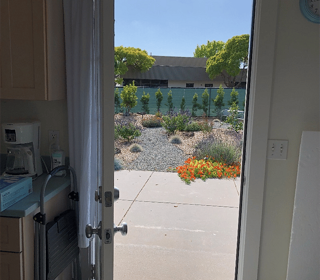 Kitchen door opens to patio and lovely backyard.