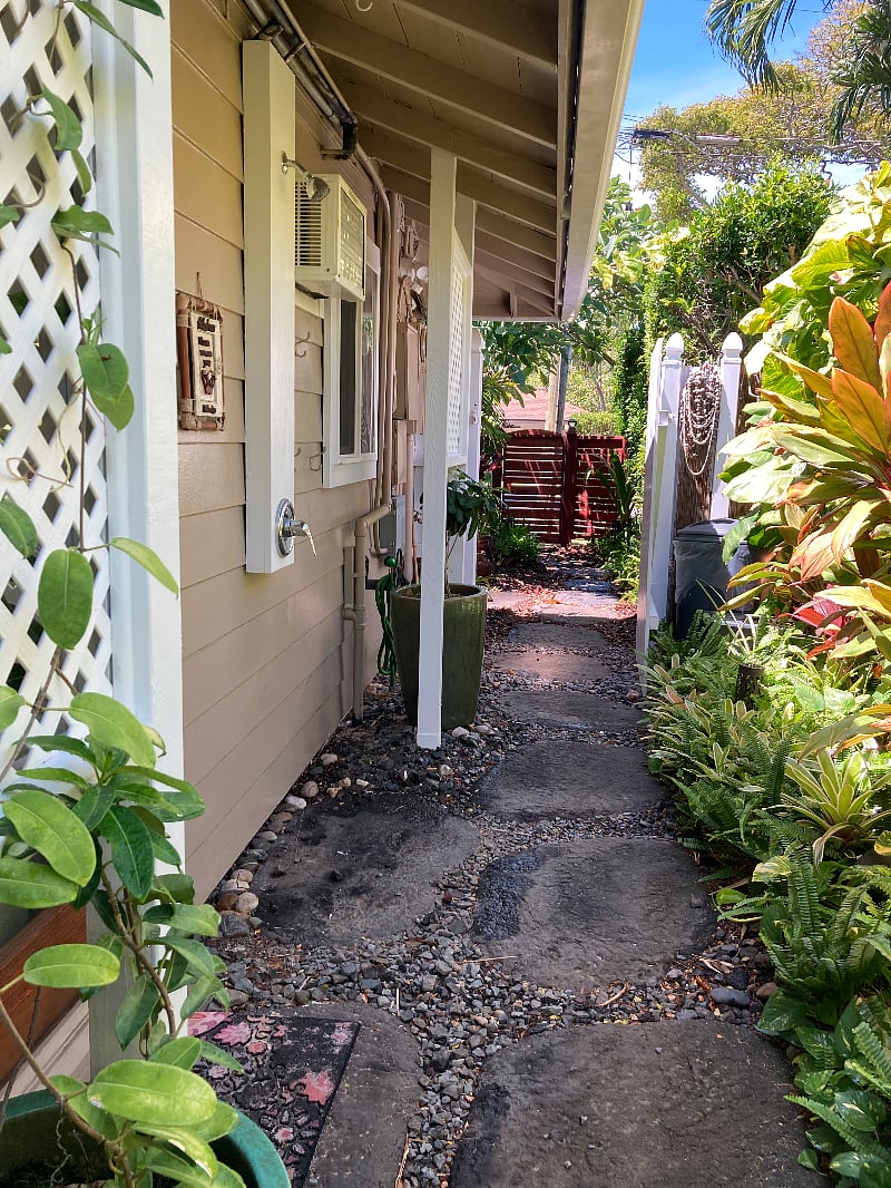 A view of the stone walking path which is facing the front of the property, The white gate closes which provides additional privacy on the walking path.